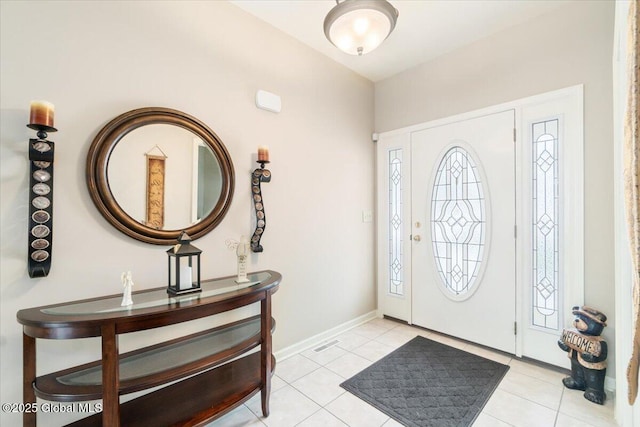 entrance foyer featuring light tile patterned floors, visible vents, and baseboards