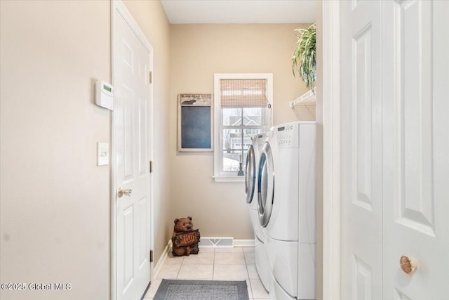 laundry room with light tile patterned floors, laundry area, visible vents, baseboards, and washer and dryer