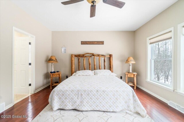 bedroom featuring wood-type flooring, visible vents, and baseboards