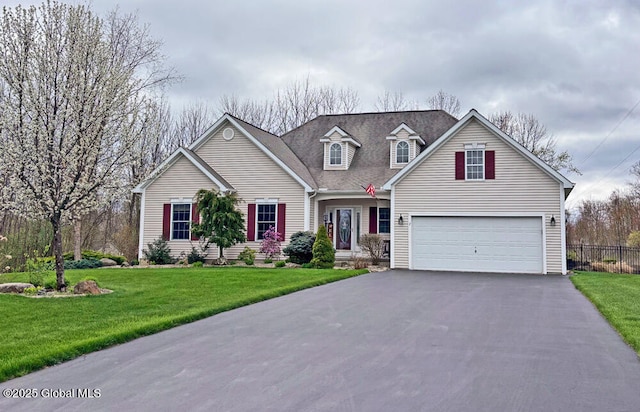 view of front of home with fence, driveway, a front lawn, and a garage