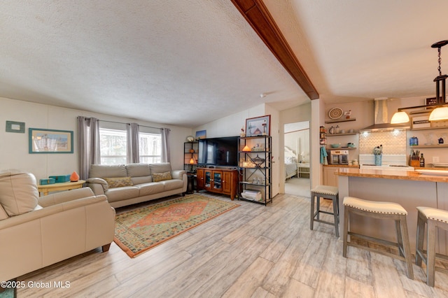 2 S Forty Rd, Hadley, NY 12835 - living room featuring lofted ceiling with beams, a textured ceiling, and light wood-style flooring