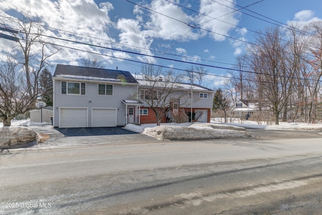 view of front of home with driveway and an attached garage