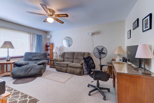 living area with a ceiling fan and carpet floors