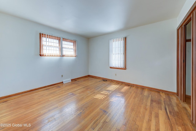 unfurnished bedroom featuring light wood finished floors and baseboards