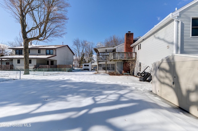 yard layered in snow featuring a residential view