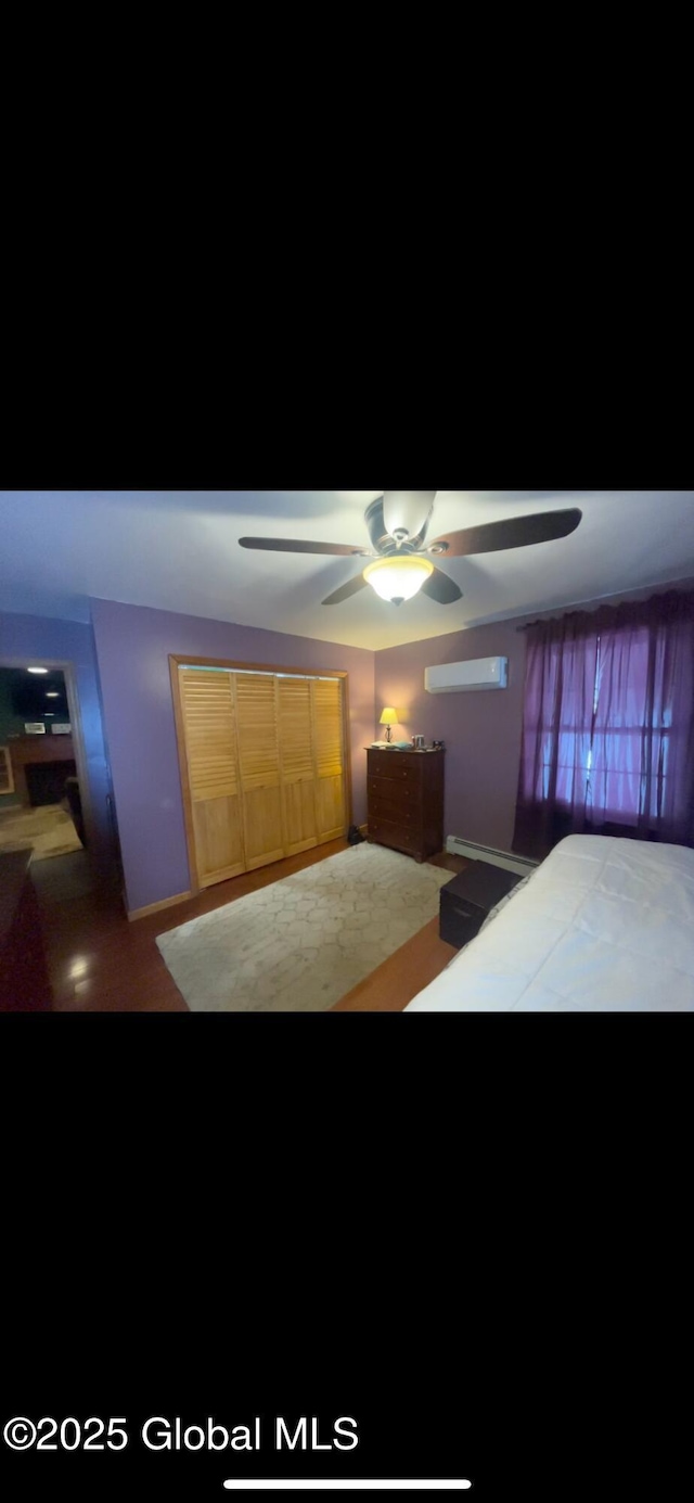 bedroom featuring a wall mounted air conditioner and ceiling fan