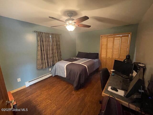 bedroom with a ceiling fan, a baseboard radiator, baseboards, and wood finished floors