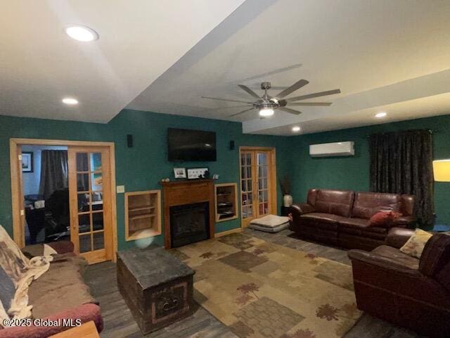 living area with recessed lighting, a fireplace, french doors, and a wall mounted AC