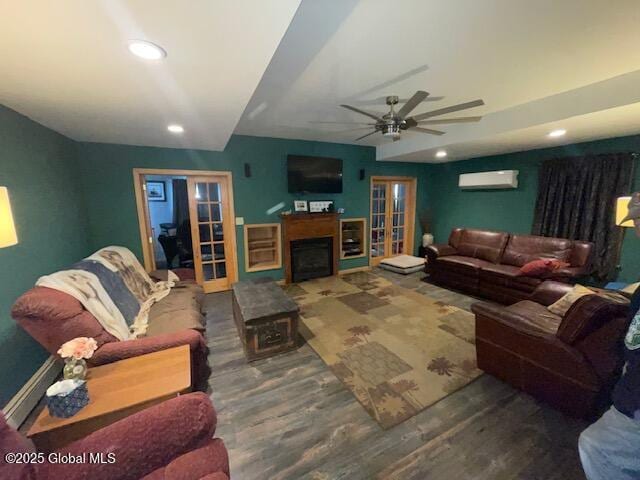 living area featuring recessed lighting, french doors, wood finished floors, and a wall mounted AC