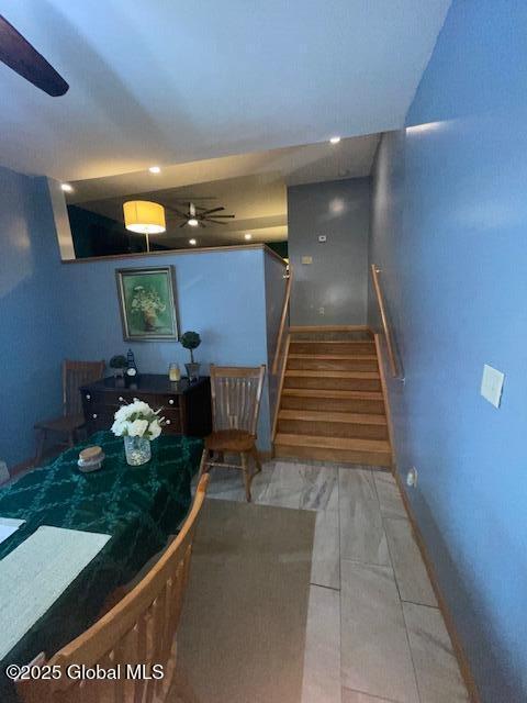 dining space featuring stairway and a ceiling fan