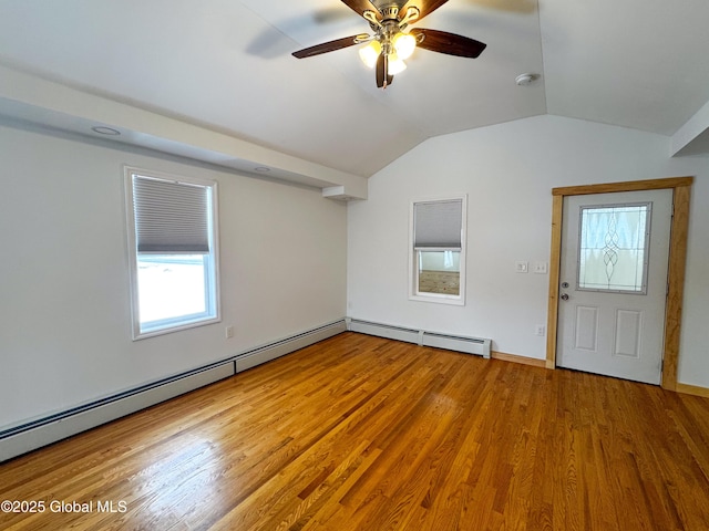 interior space featuring a ceiling fan, a baseboard radiator, vaulted ceiling, and wood finished floors