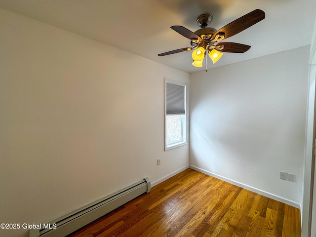 unfurnished room with a baseboard heating unit, light wood-style flooring, and baseboards