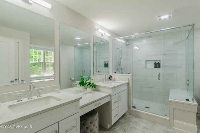 bathroom with a shower stall, vanity, and marble finish floor
