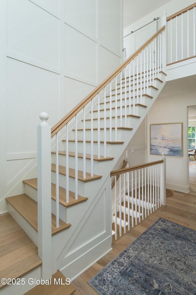 stairs featuring wood finished floors
