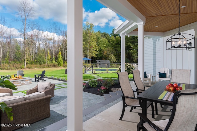 view of patio / terrace with outdoor dining area and an outdoor fire pit