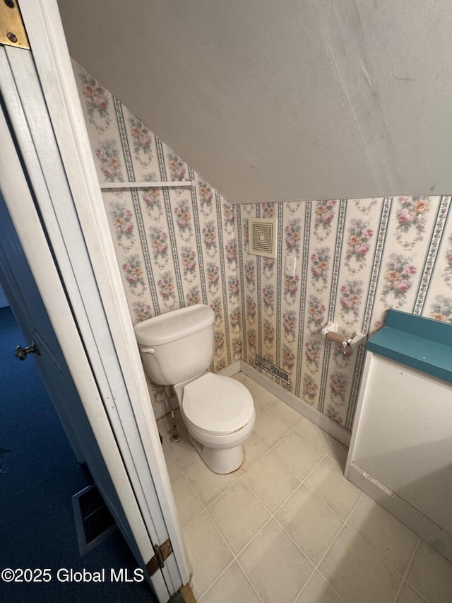 bathroom with tile patterned floors, visible vents, and toilet