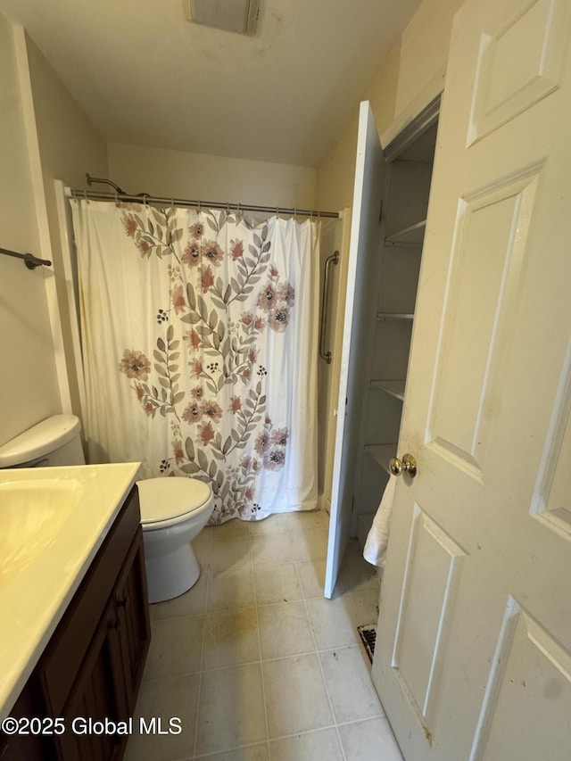 full bath featuring vanity, a shower with curtain, visible vents, tile patterned floors, and toilet