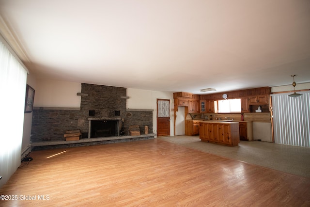 unfurnished living room featuring a fireplace and light wood-style flooring