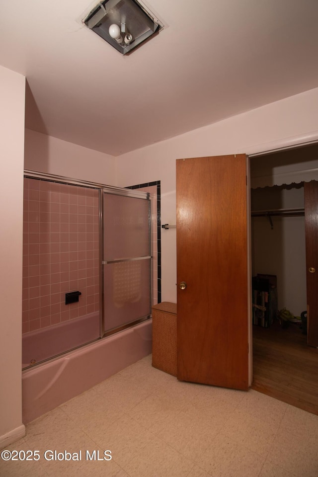 full bathroom featuring combined bath / shower with glass door, visible vents, and tile patterned floors