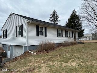 view of side of property with a yard