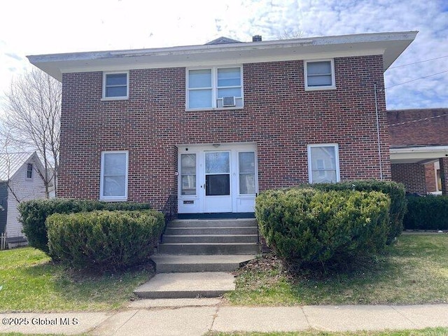 traditional home with entry steps and brick siding