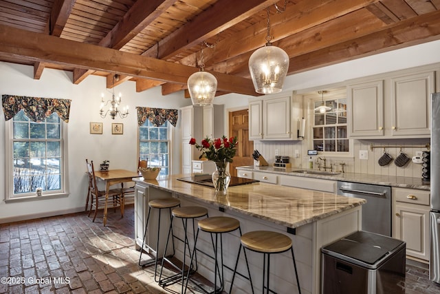 kitchen featuring a sink, a kitchen island, brick floor, black electric stovetop, and dishwasher