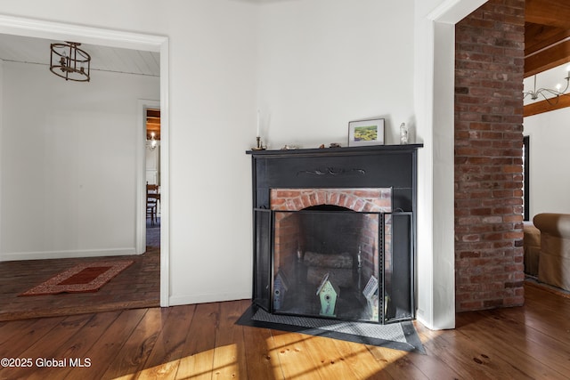 interior details featuring baseboards, wood finished floors, and a fireplace