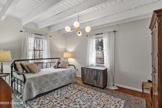 bedroom featuring baseboards, wood ceiling, beam ceiling, wood finished floors, and a notable chandelier