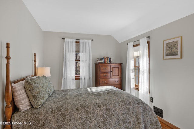 bedroom with visible vents and vaulted ceiling