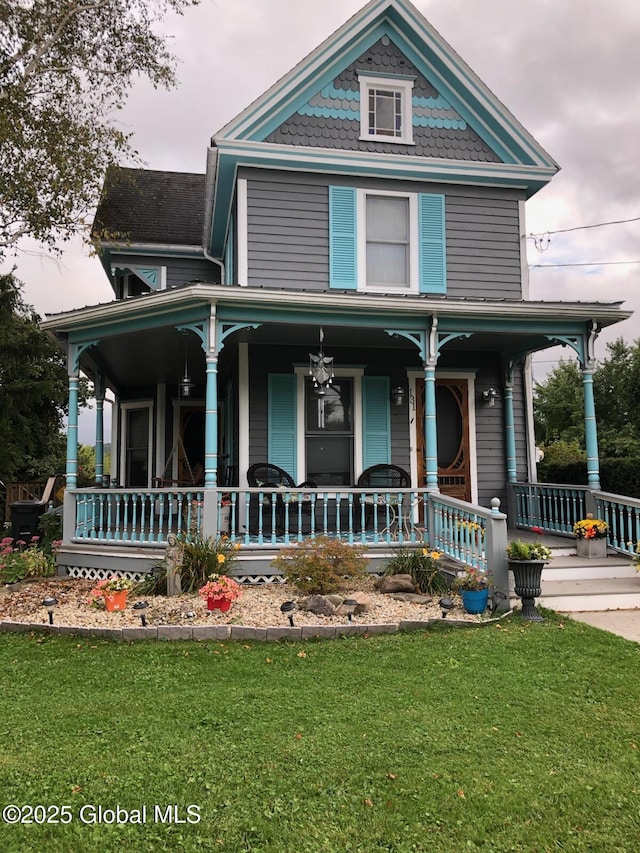 victorian house with covered porch and a front yard