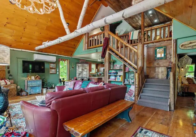 living area featuring a chandelier, a wall unit AC, wooden ceiling, hardwood / wood-style flooring, and stairway