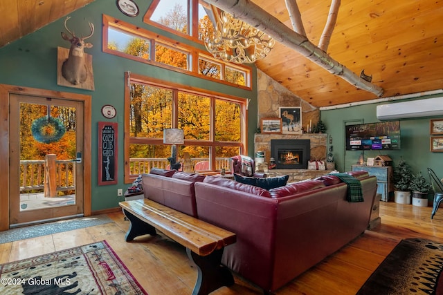 living room with wood-type flooring, high vaulted ceiling, a stone fireplace, and a wall mounted air conditioner