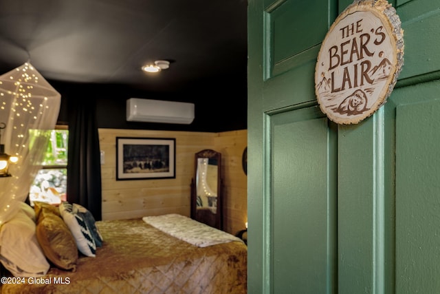 bedroom with a wall mounted air conditioner and wood walls