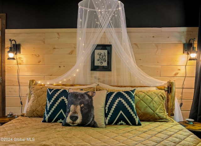 bedroom featuring wooden walls