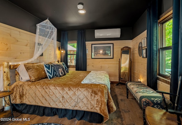 bedroom with wood walls, wood-type flooring, and a wall mounted air conditioner