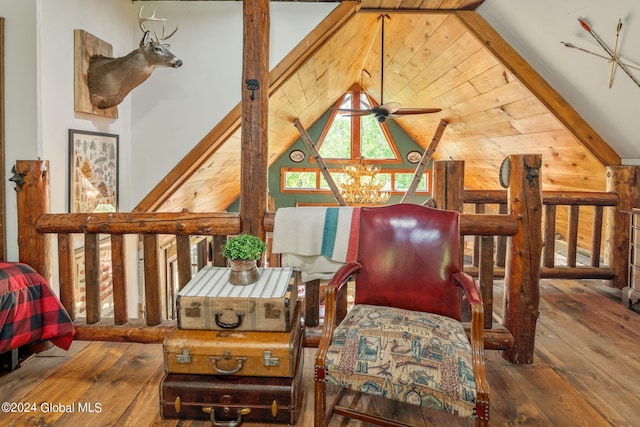 living area featuring lofted ceiling with beams and wood-type flooring