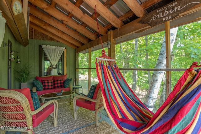 sunroom featuring vaulted ceiling