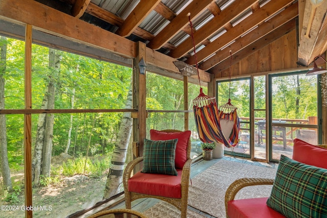 sunroom / solarium featuring vaulted ceiling