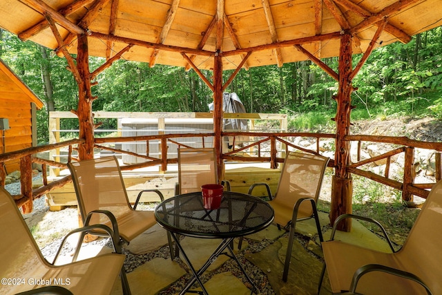 exterior space with outdoor dining area and a view of trees