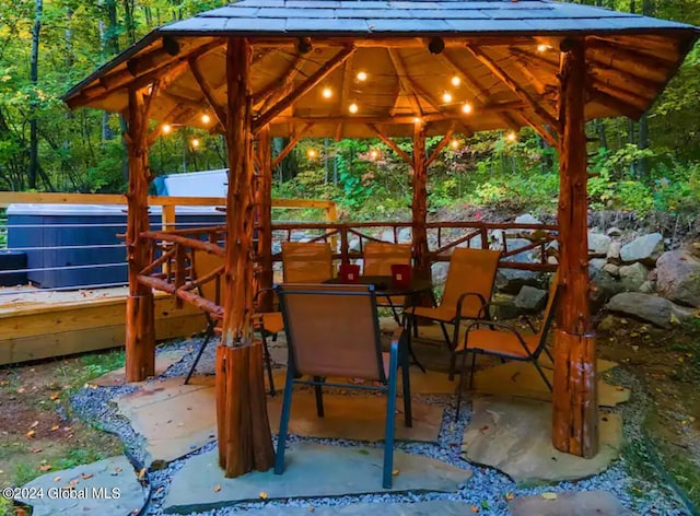 view of patio featuring outdoor dining area and a gazebo