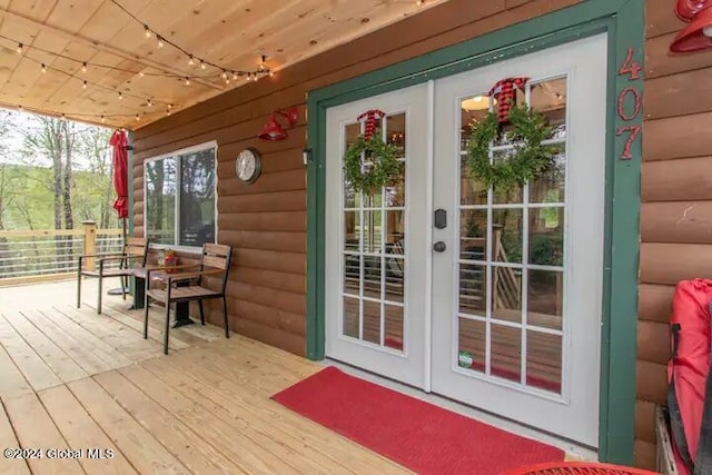 exterior space featuring wood ceiling, track lighting, and french doors