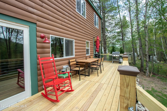 wooden terrace featuring a grill