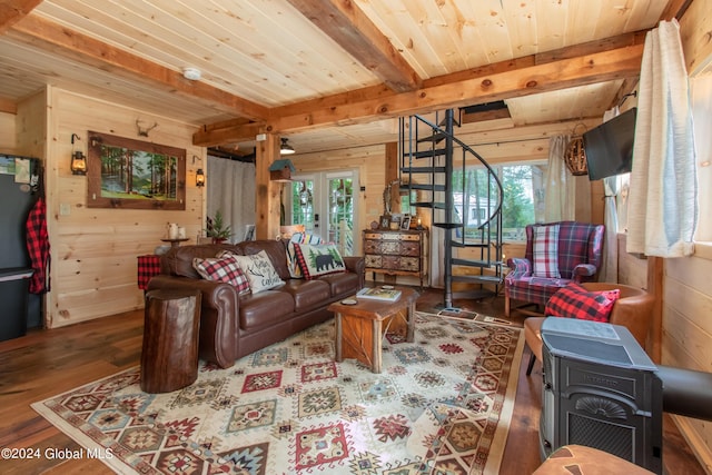 living area featuring wooden ceiling, wood walls, wood finished floors, stairway, and beam ceiling