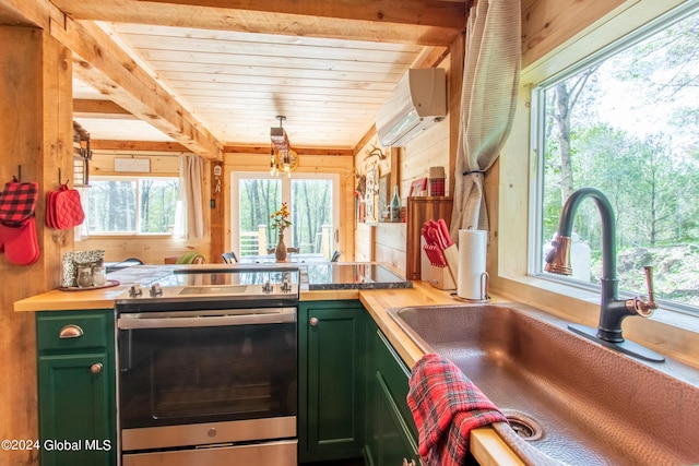 kitchen with electric range, green cabinets, a sink, and a wall mounted AC