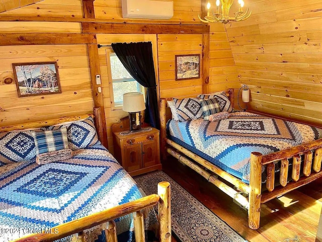 bedroom with wood walls and a notable chandelier