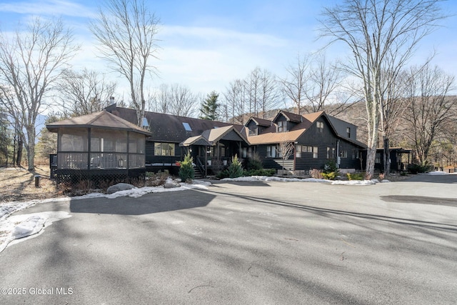 view of front of property with a residential view and a wooden deck