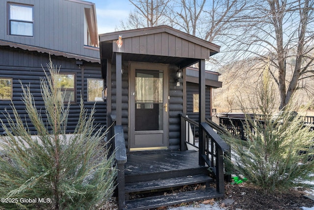 property entrance featuring faux log siding