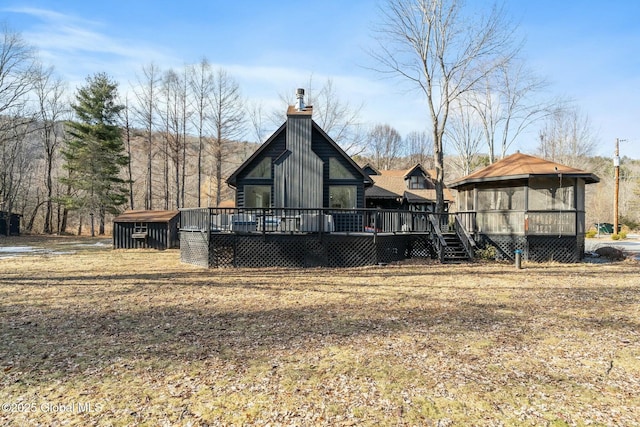 rear view of house featuring a deck