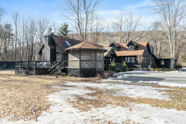 view of front facade with a wooden deck