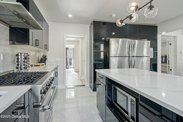 kitchen with decorative backsplash, appliances with stainless steel finishes, modern cabinets, dark cabinets, and under cabinet range hood